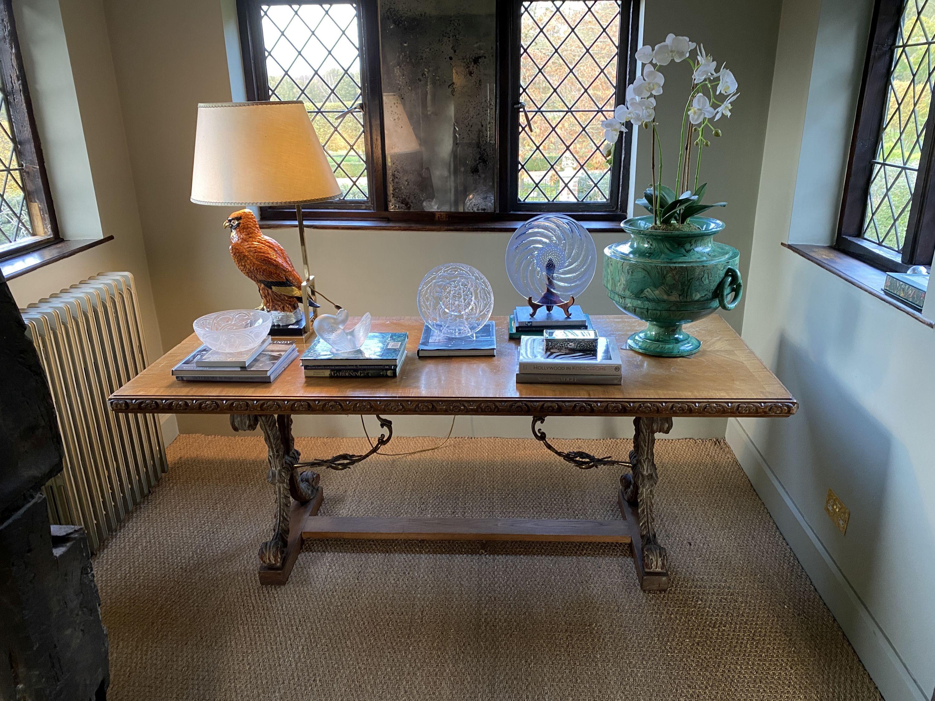 A Spanish style crossbanded walnut centre table, with floral carved border and gilt metal mounted scrolling foliate X shaped supports, width 197cm depth 82cm height 76cm